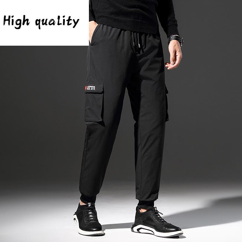 outdoor winter northeast with thick white duck down outside a man wear to keep warm young overalls and wool trousers, Black