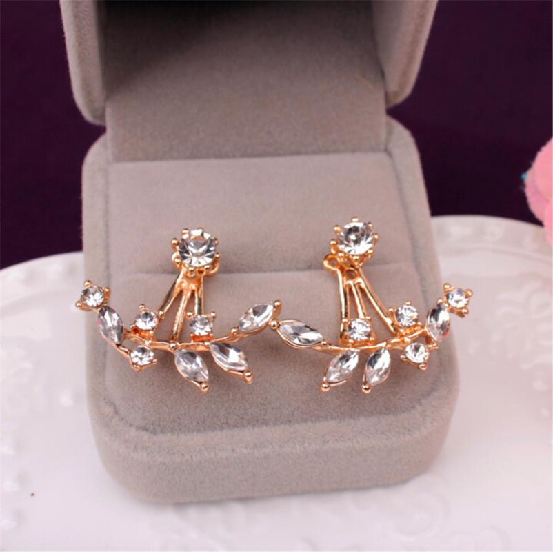 Women's jewelry earrings, shiny metal leaves and studded with crystal studs and a new crystal stud on the back of a branch
Women's jewelry earrings, shiny metal leaves and studded with crystal studs and a new crystal stud on the back of a branch