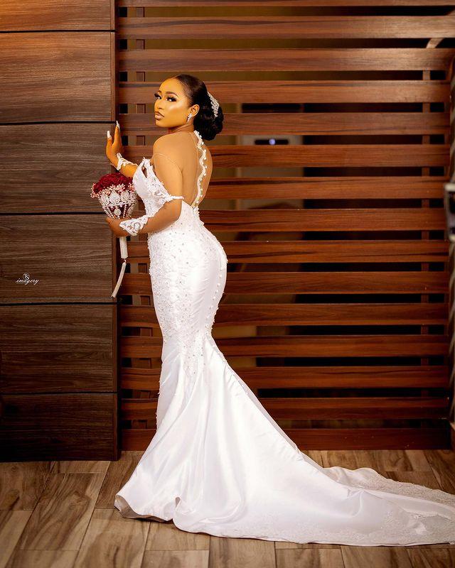 African Sexy Arabic Mermaid Wedding Dresses Jewel Neck Illusion Crystal Beaded Long Sleeves Button Back Satin Court Train Plus Size Bridal Gowns