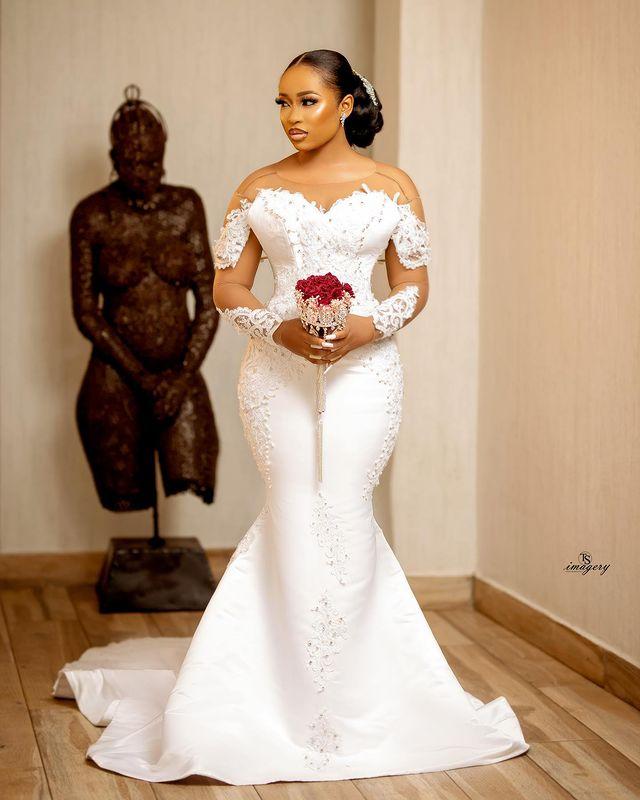 African Sexy Arabic Mermaid Wedding Dresses Jewel Neck Illusion Crystal Beaded Long Sleeves Button Back Satin Court Train Plus Size Bridal Gowns