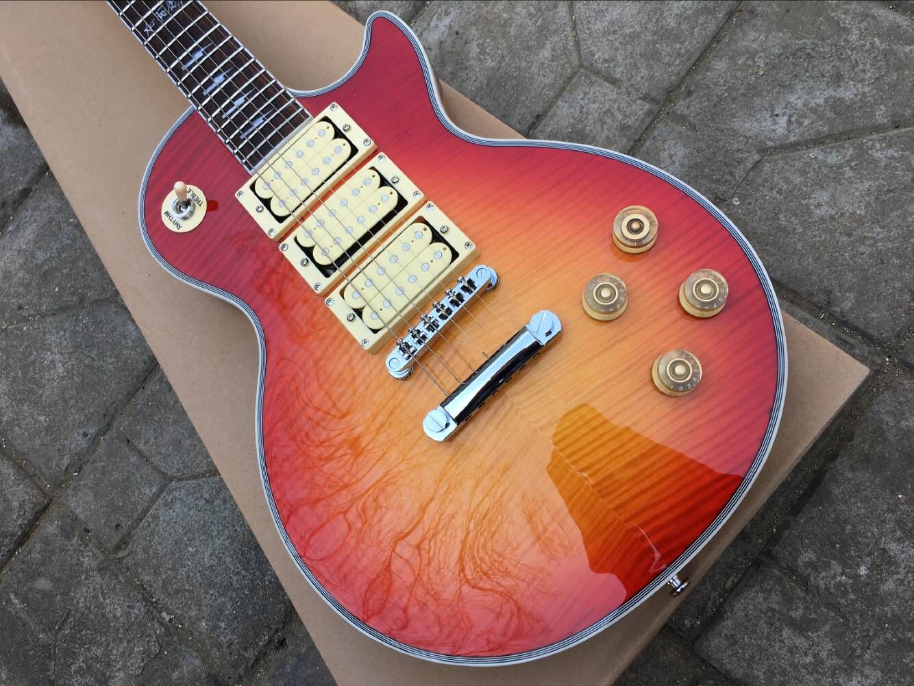 Ace Frehley Signature Cherry Sunburst Flame Maple Top Electric Guitar Mirror Back Covers, 3 Humbucker Pickups, Grover Tuner, Chrome Hardware, China Chibson OEM Guitars
Ace Frehley Signature Cherry Sunburst Flame Maple Top Electric Guitar Mirror Back Covers, 3 Humbucker Pickups, Grover Tuner, Chrome Hardware, China Chibson OEM Guitars