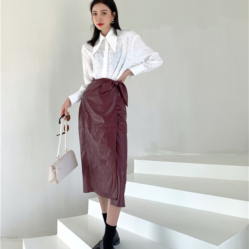 Nomikuma One-piece PU Leather Women Skirt Bow Tie Stretch High Waist Skirts Spring New Sexy Split A-line Mujer Faldas 6D931 210427