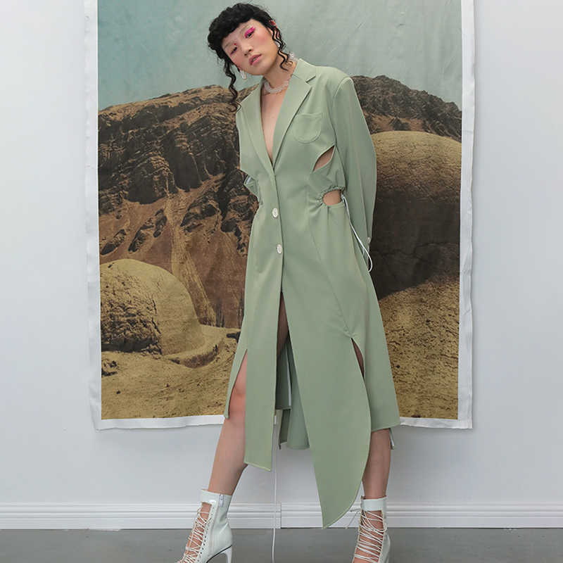 TWOTWINSTYLE Irregular Split Windbreaker For Female Lapel Collar Long Sleeve High Waist Hollow Out Drawstring Trench Coats Women 210820