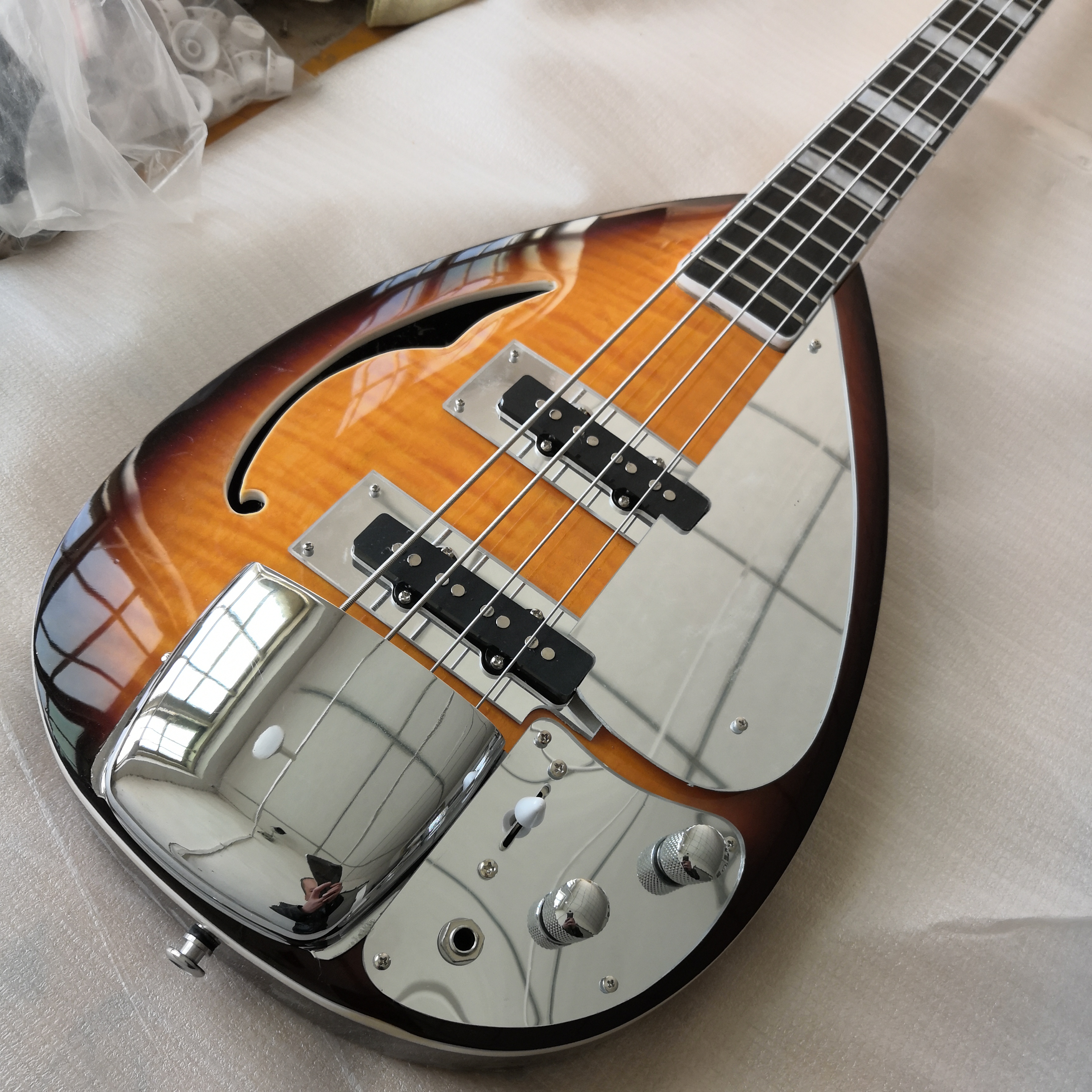 4 Strings Sunburst Tear Drop Vox Phantom Electric Bass Guitar Semi Hollow Body, Single F Hole, Large Block Inlay, Bigs Bridge Cover
4 Strings Sunburst Tear Drop Vox Phantom Electric Bass Guitar Semi Hollow Body, Single F Hole, Large Block Inlay, Bigs Bridge Cover