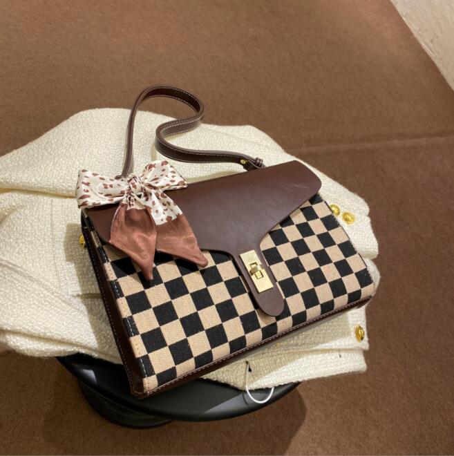 Factory wholesale winter fashion checkerboard women shoulder bags elegant atmosphere plaid handbag simple retro ribbon color matching leather messenger bag