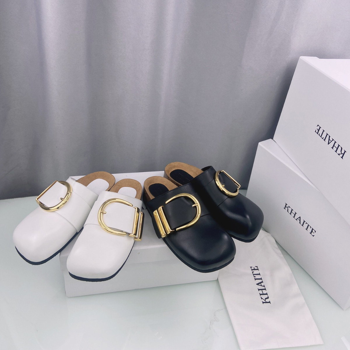 Khaite Downing gold-tone buckled leather Mules slippers Luxe slip-on Clog beach shoes Rounded closed toes casual flats for women Luxury Designers factory footwear, Black
Khaite Downing gold-tone buckled leather Mules slippers Luxe slip-on Clog beach shoes Rounded closed toes casual flats for women Luxury Designers factory footwear, Black