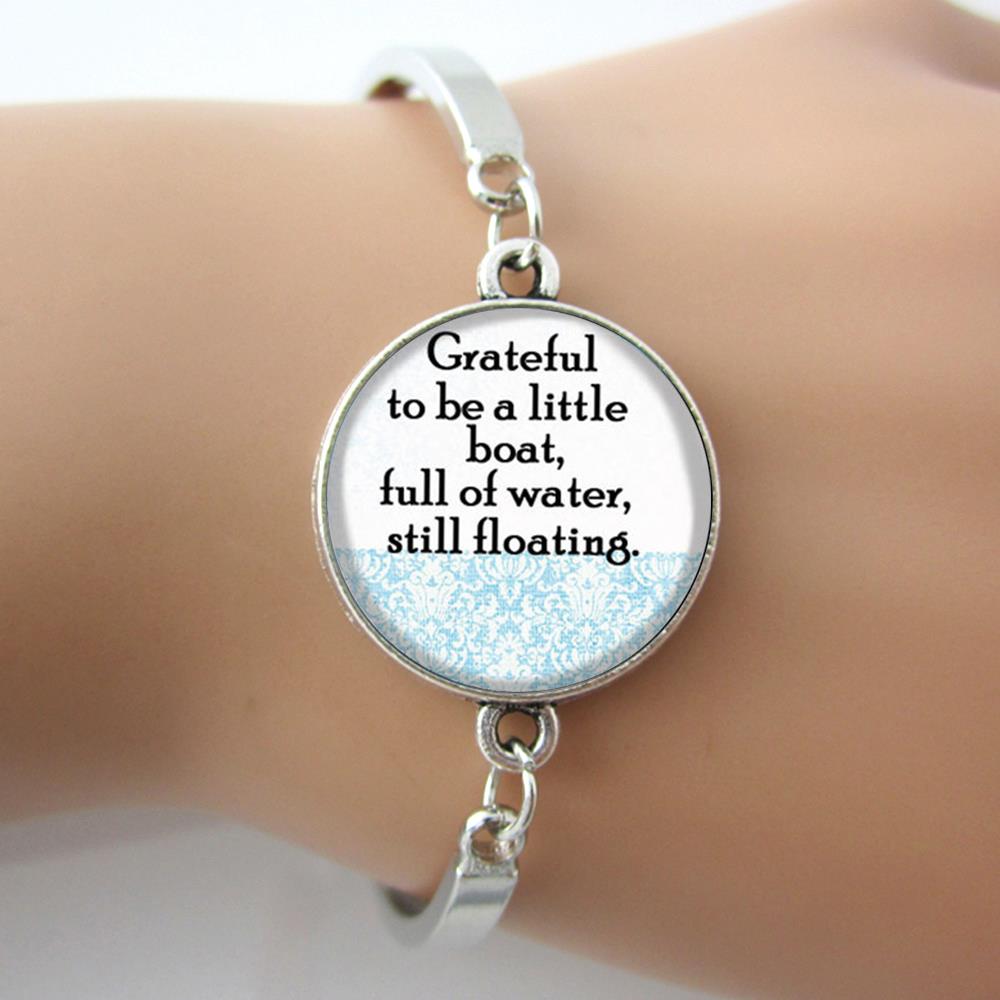 Glass Dome Bangle Art Picture with Quote "Grateful to be a little boat,full of water,still floating" Silver Metal Bracelet 2016
Glass Dome Bangle Art Picture with Quote "Grateful to be a little boat,full of water,still floating" Silver Metal Bracelet 2016