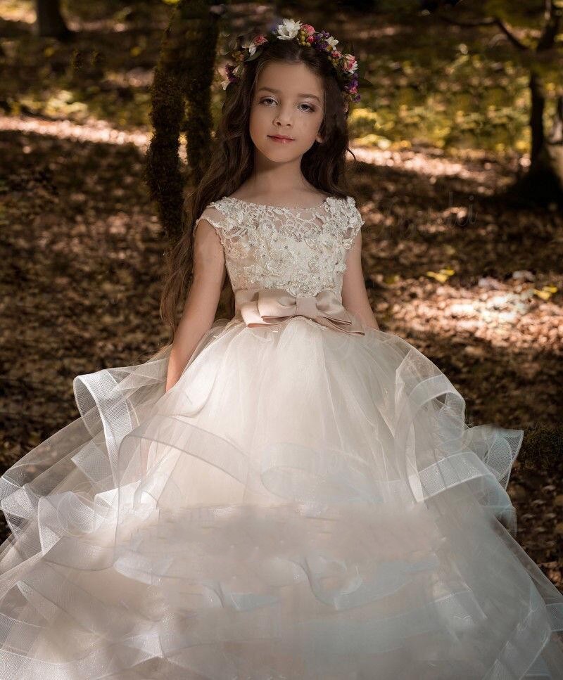 lovely floorlength flower girl gown featuring beaded lace overlay and delicate tulle layers perfect for weddings
