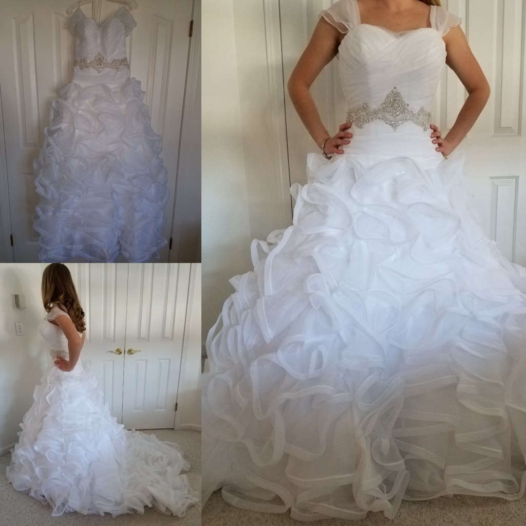 White Organza Ruffles Pleated Ball Gown Wedding Dresses Capped Sleeve Strapless Sweetheart Crystal Beaded Belt Tiered Skirts Bridal Gow
White Organza Ruffles Pleated Ball Gown Wedding Dresses Capped Sleeve Strapless Sweetheart Crystal Beaded Belt Tiered Skirts Bridal Gow