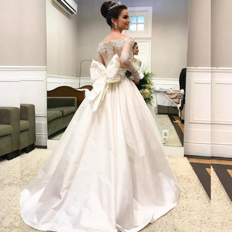 Arabic Long Sleeve Wedding Dresses Sheer Neck Off the Shoulder Beaded Lace Appliques Illusion Back Taffeta Bridal Gowns with Oversize Bow, Custom made from color chart
Arabic Long Sleeve Wedding Dresses Sheer Neck Off the Shoulder Beaded Lace Appliques Illusion Back Taffeta Bridal Gowns with Oversize Bow, Custom made from color chart