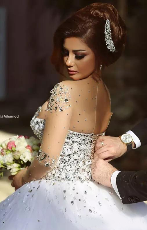 2020 Arabic Luxury Crystal Wedding Dresses with Rhinestone Beads A Line Sheer Illusion Crew Neck Long Sleeves Floor Length Bridal Gowns