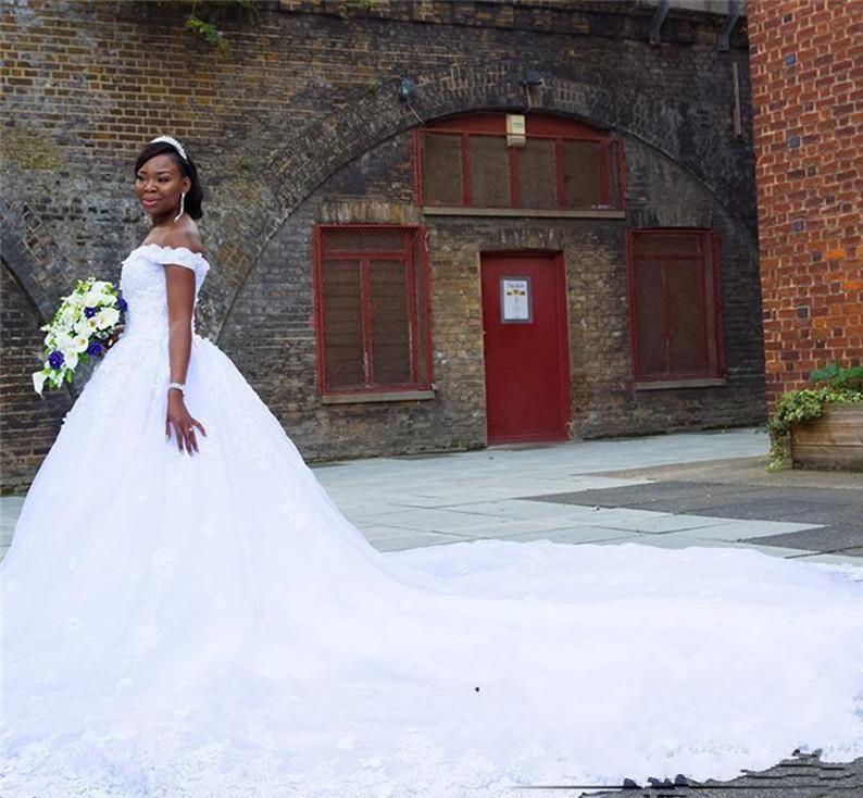 2018 African A Line Wedding Dresses Off Shoulder Lace Appliques Beaded 3D Floral Country Cathedral Train Black Girl Plus Size Bridal Gowns