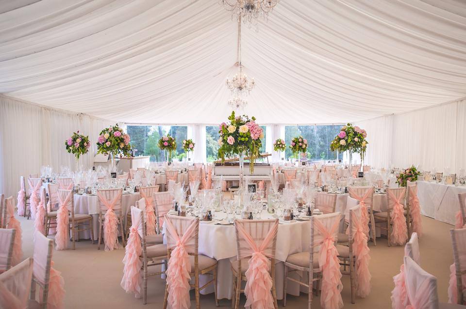 vintageinspired blush pink chair covers with fashionable ruffled sashes for weddings
