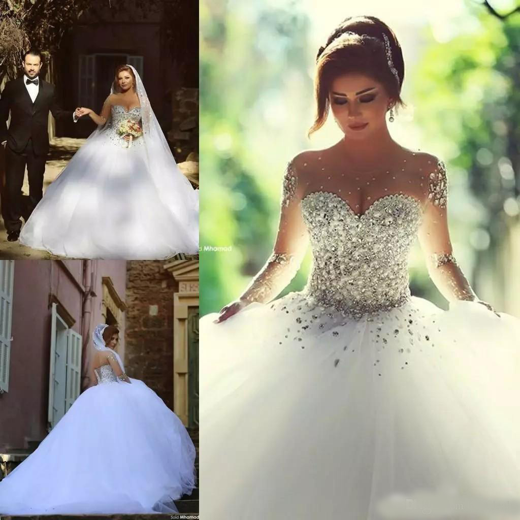 2020 Arabic Luxury Crystal Wedding Dresses with Rhinestone Beads A Line Sheer Illusion Crew Neck Long Sleeves Floor Length Bridal Gowns
