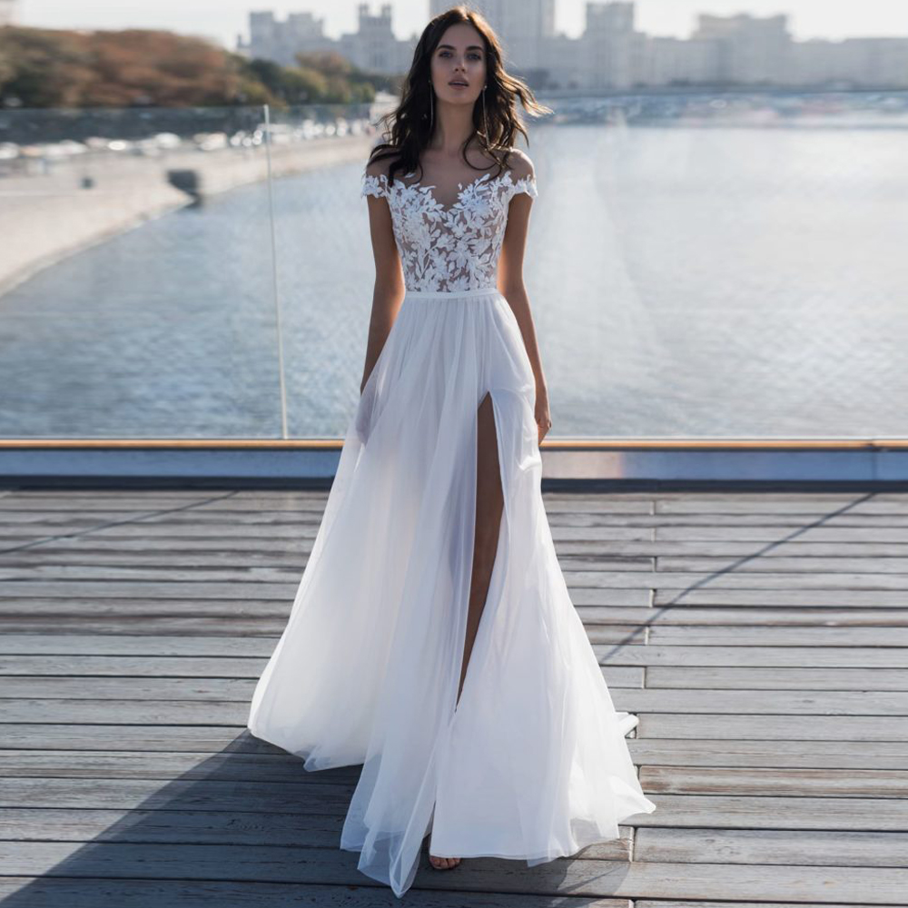 New Arrive Boho Beach Wedding Dresses 2020 Sheer Neck Cover Button Back Lace Appliques A Line Side Split Bridal Gowns Vestido de noiva, Champagne
New Arrive Boho Beach Wedding Dresses 2020 Sheer Neck Cover Button Back Lace Appliques A Line Side Split Bridal Gowns Vestido de noiva, Champagne