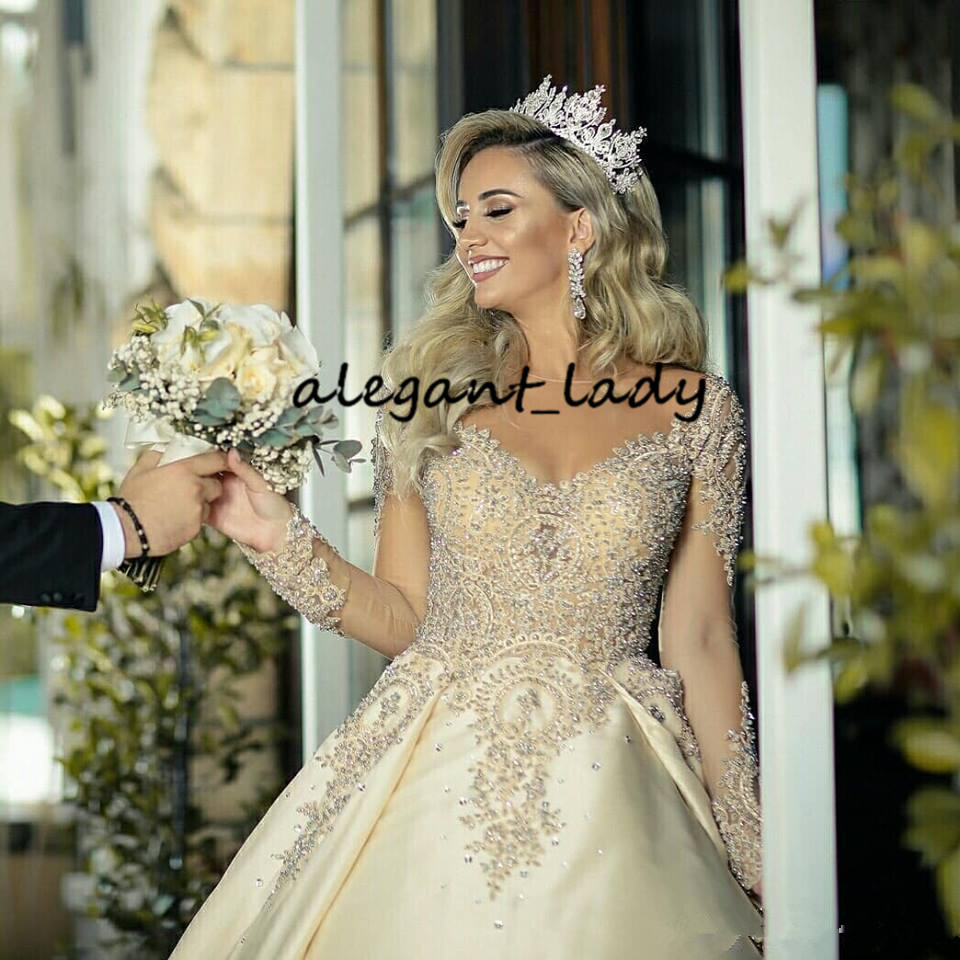 Illusion Long Sleeve Wedding Dresses 2020 Sheer Neck Gold Champagne Sparkly Beaded Lace Applique Princess Big Train Wedding Gown