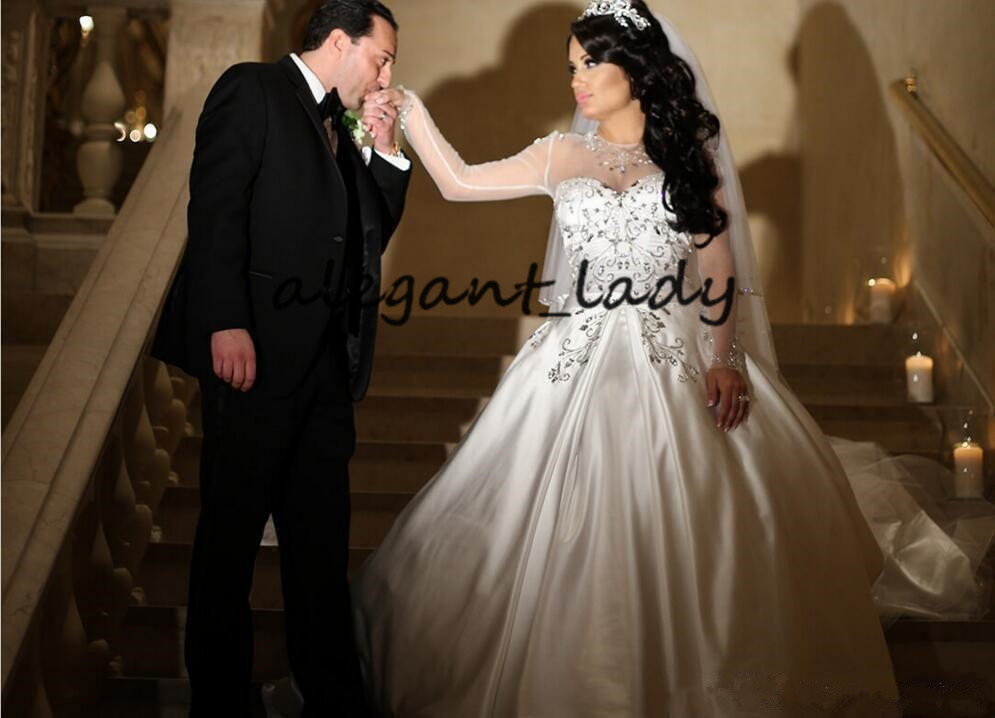 Illusion Long Sleeve Princess Wedding Dresses 2020 Sparkly Crystal Beaded Sheer Neck Puffy Skirt Church Bride Wedding Gowns