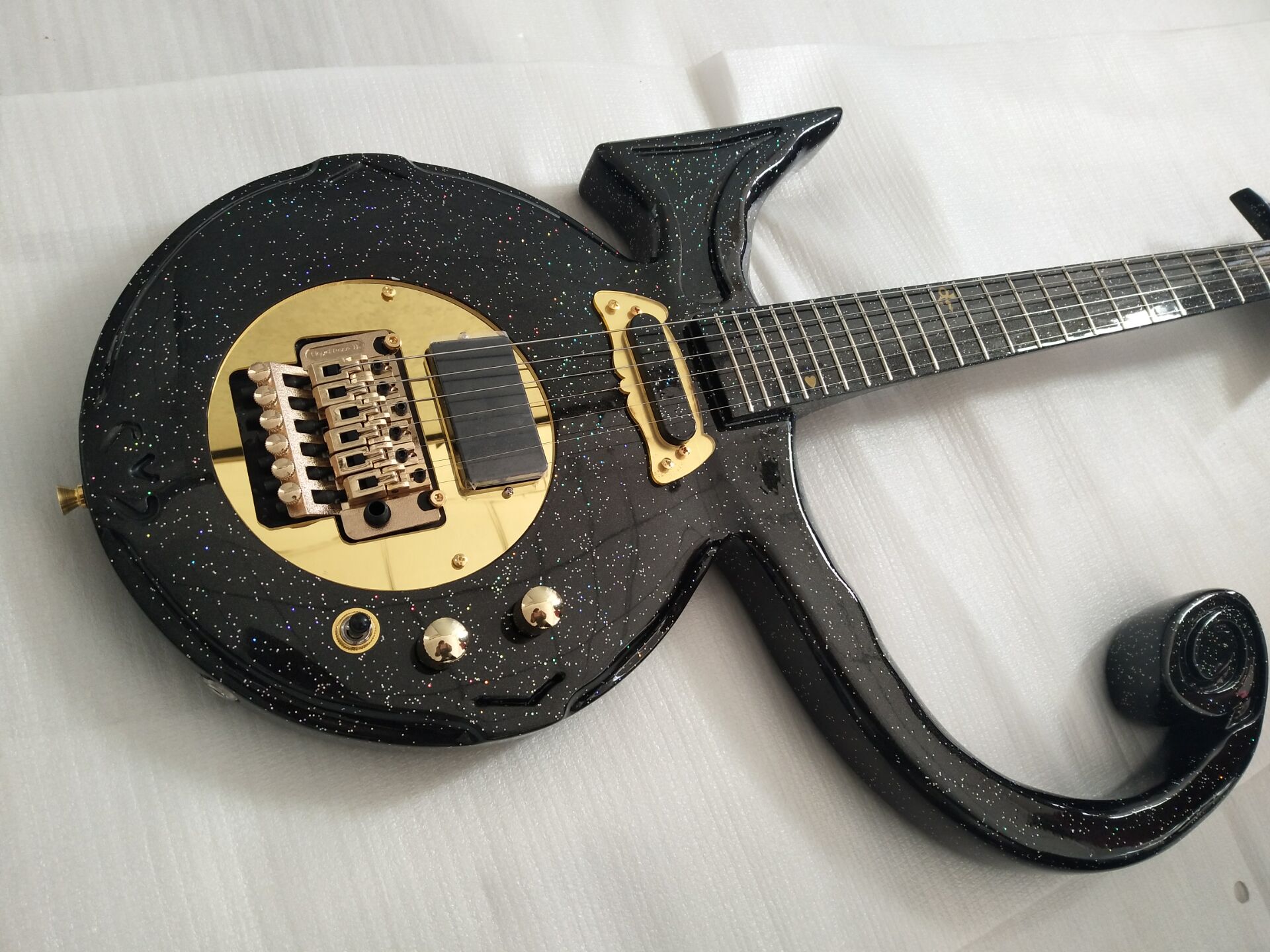 Rare Diamond Series Prince Love Symbol Big Sparkle Metallic Black Electric Guitar Floyd Rose Tremolo Tailpiece, EMG Pickup, Gold Hardware
Rare Diamond Series Prince Love Symbol Big Sparkle Metallic Black Electric Guitar Floyd Rose Tremolo Tailpiece, EMG Pickup, Gold Hardware