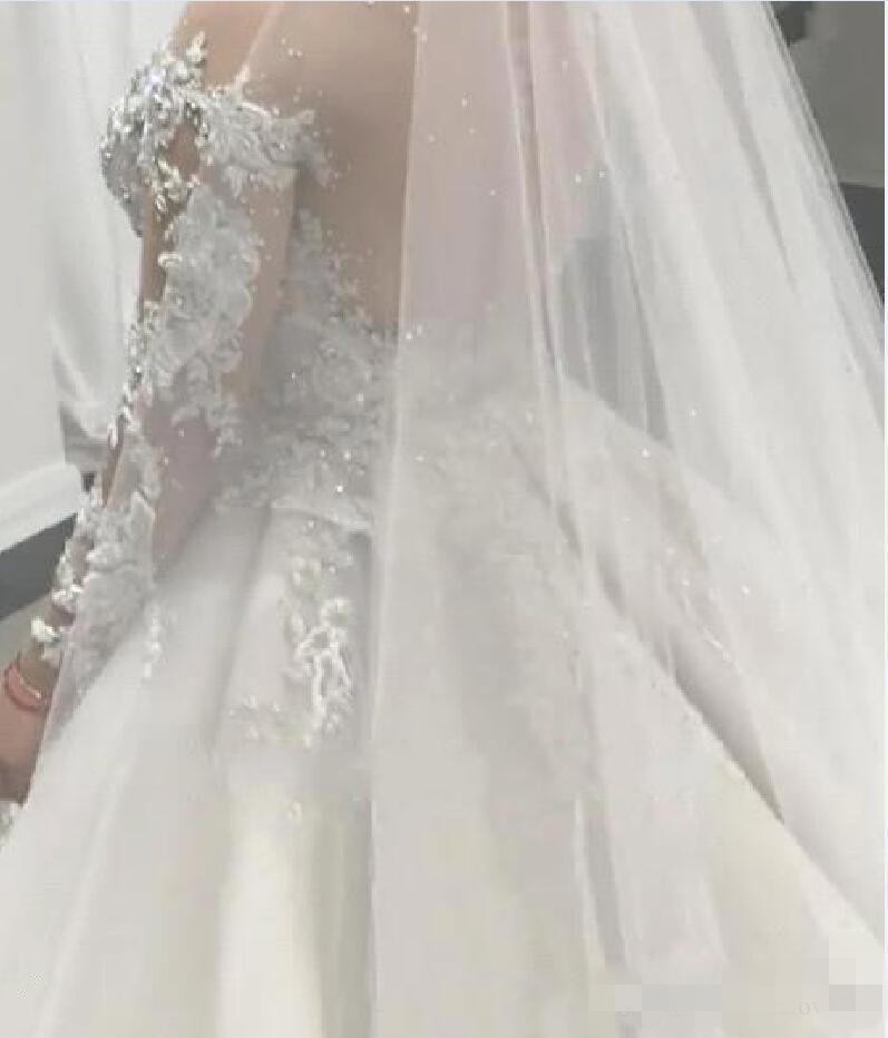 Beaded Dresses Long Sleeves Lace Applique Crystals Overskirt Sheer Neck Chapel Train Wedding Bridal Gown Vestido De Novia