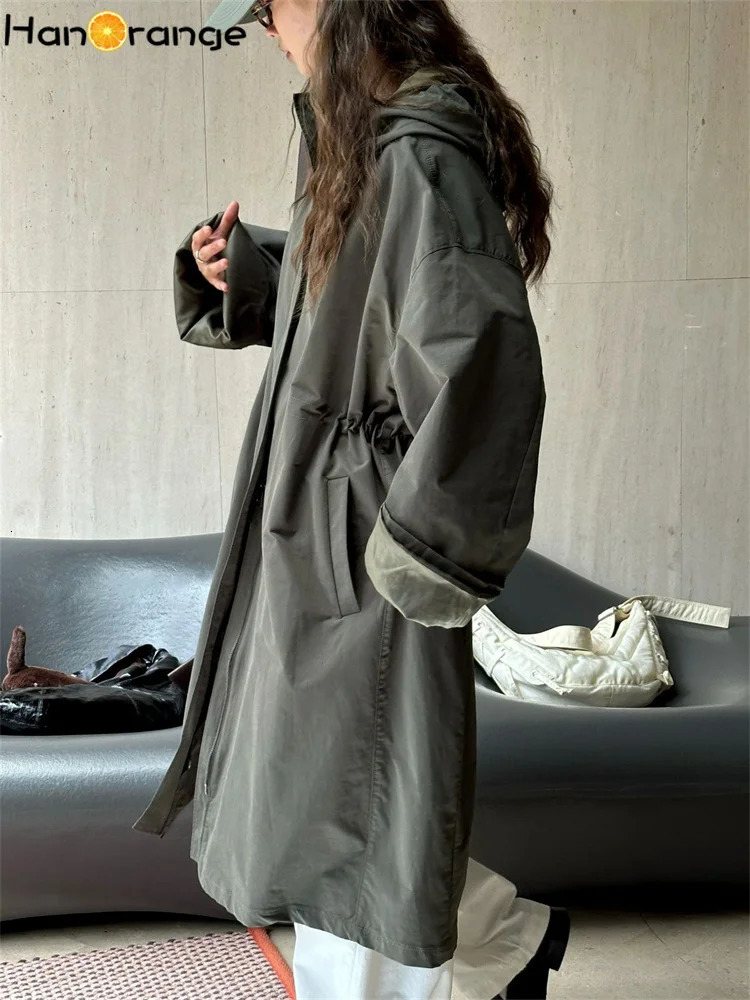 HanOrange 2024 Autumn Leisure Hooded Silhouette Windbreaker Women Windproof Long Trench Jacket Military GreenBeige Apricot 251231
