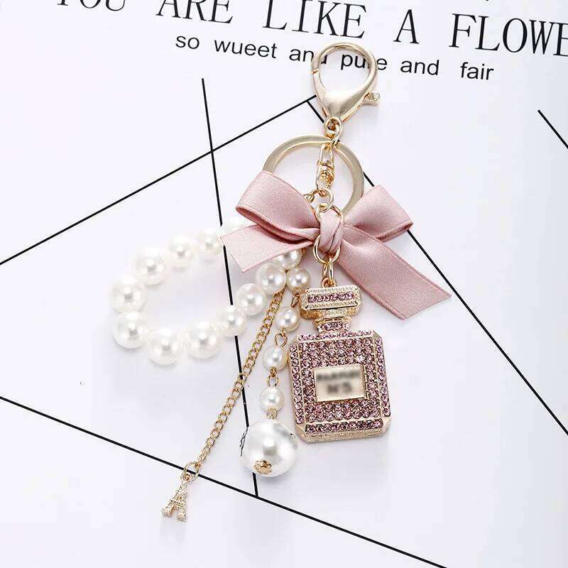 New Model Small Fragrant Wind Pearl Perfume Bottle Bow Chain Fashion Lady Bag Luxury Accessories Car Key Buckle XJ260106