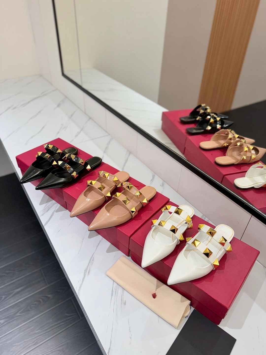 The textured hardware highlights the luxurious feel of the slippers