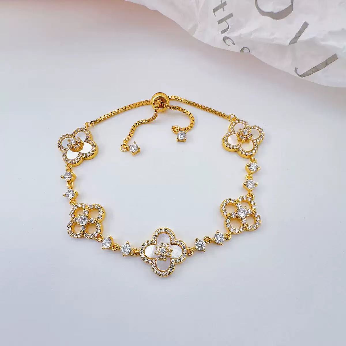 Elegant Pink Floral Design Charm Bangle: Four-Leaved Lucky Charms Accented by Tiny Sparkling Cubic Zirconia Stones for Women's Jewelry Collection