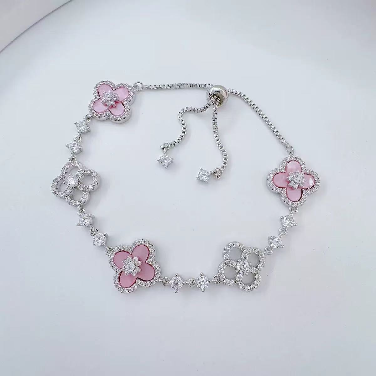 Elegant Pink Floral Design Charm Bangle: Four-Leaved Lucky Charms Accented by Tiny Sparkling Cubic Zirconia Stones for Women's Jewelry Collection
