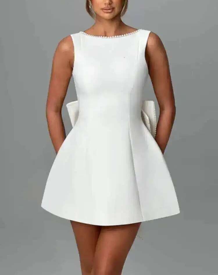 Designer's elegant mini dress with pearl bow details - perfect for parties, weddings, and special occasions