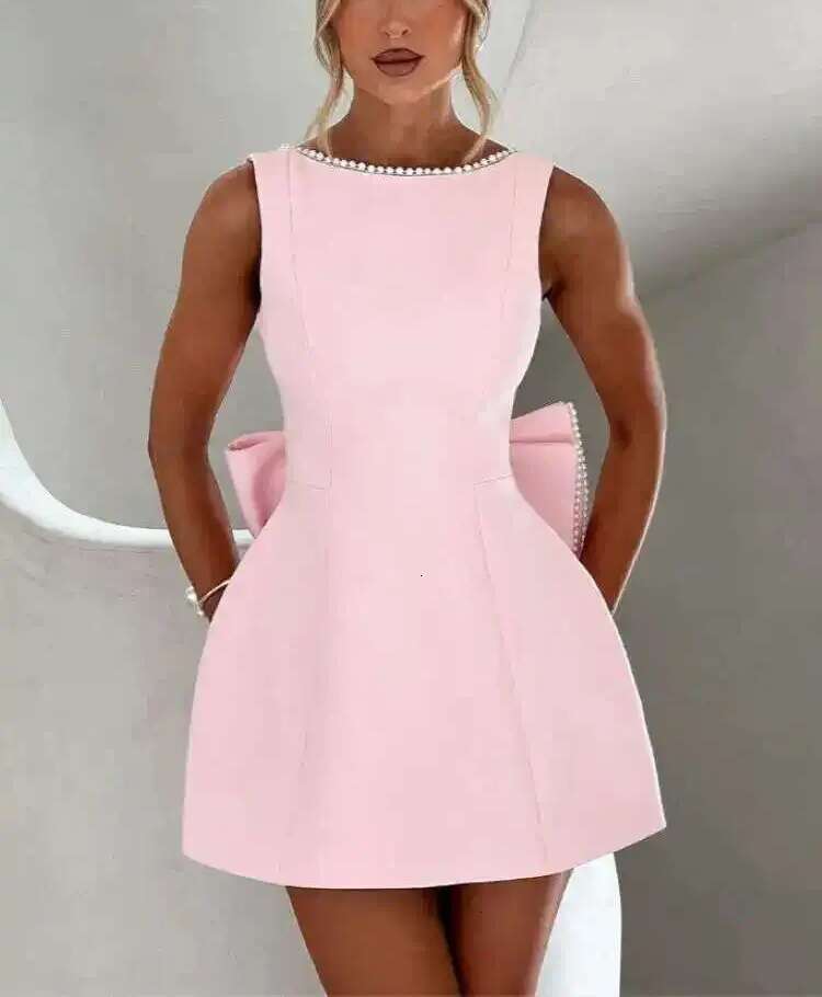 Designer's elegant mini dress with pearl bow details - perfect for parties, weddings, and special occasions