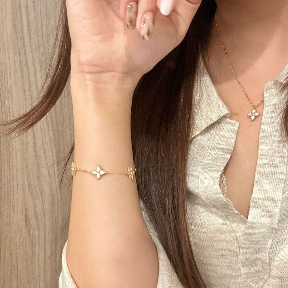 Lightweight dainty gold tone four leaf clover motif bracelet with of inlay smooth accents for Women