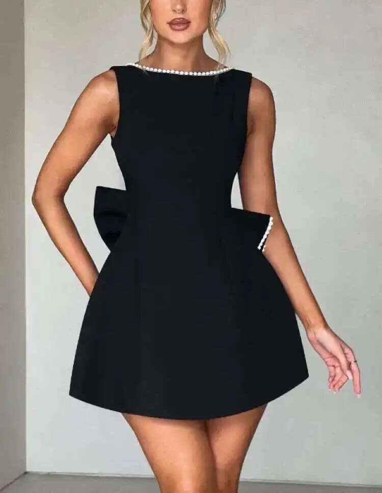 Designer's elegant mini dress with pearl bow details - perfect for parties, weddings, and special occasions