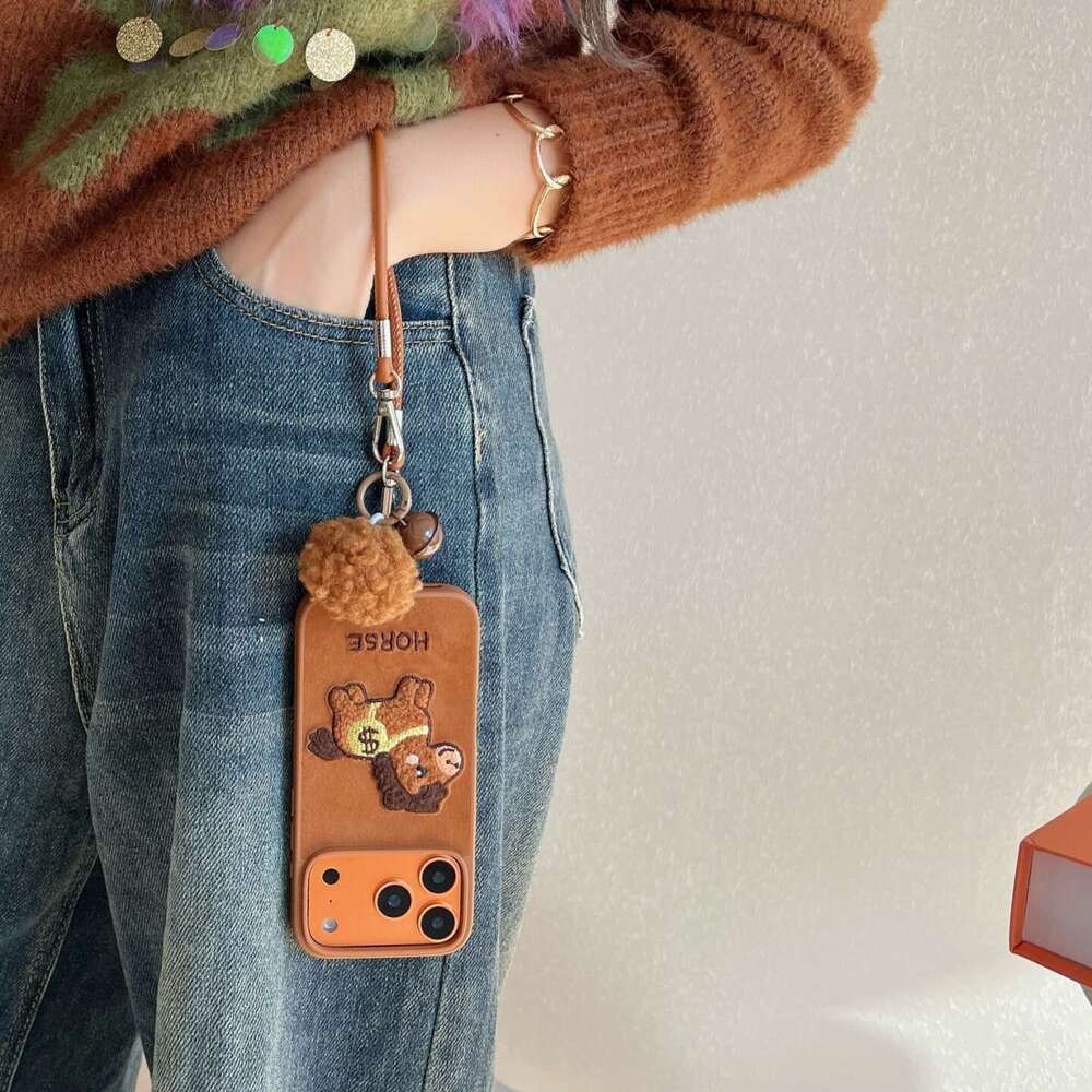 Embroidered Money Pony for Apple 17 Pro Max, iPhone 16/15/14 with Hand Strap and Pom-Pom Soft Case S260128