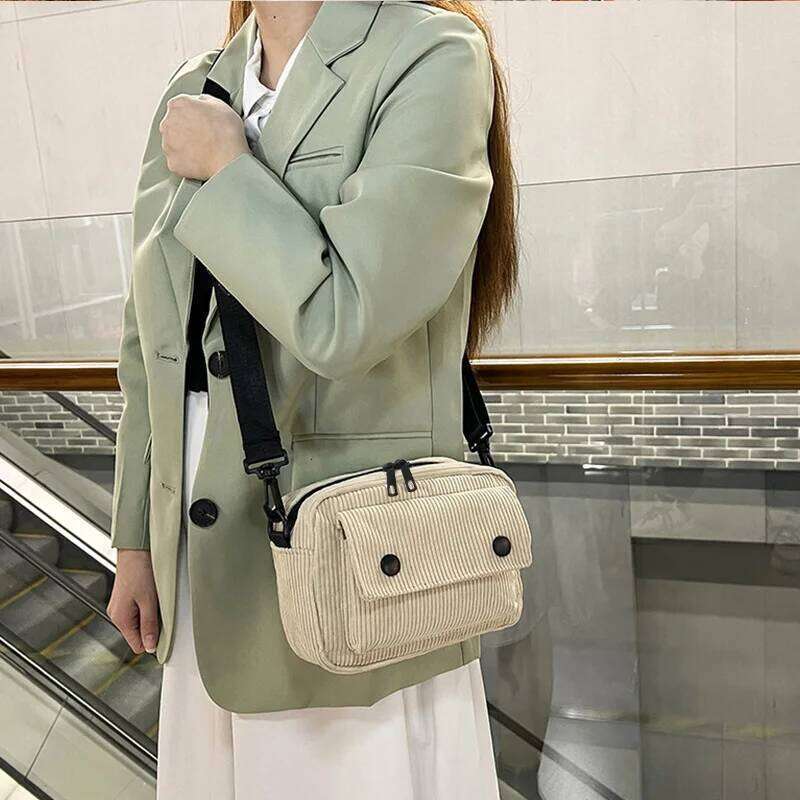 Neutral men's and women's cross-body bag shoulder strap, made of corduroy material, with a flap design on the outside.