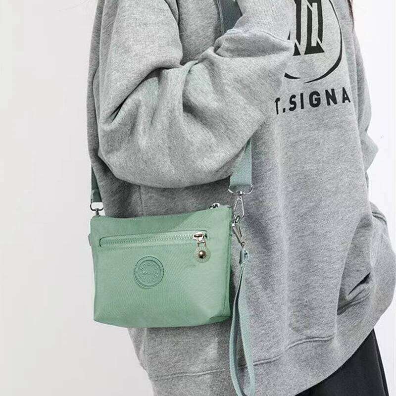 Neutral style men's women's mini shoulder bags in nylon material, suitable for travel and business use. XJ260129