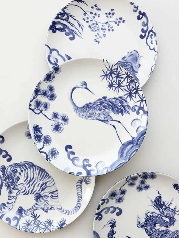 This set of four blue and white porcelain plates with dragon, tiger, and crane motifs brings auspicious charm to your home decor.T260304