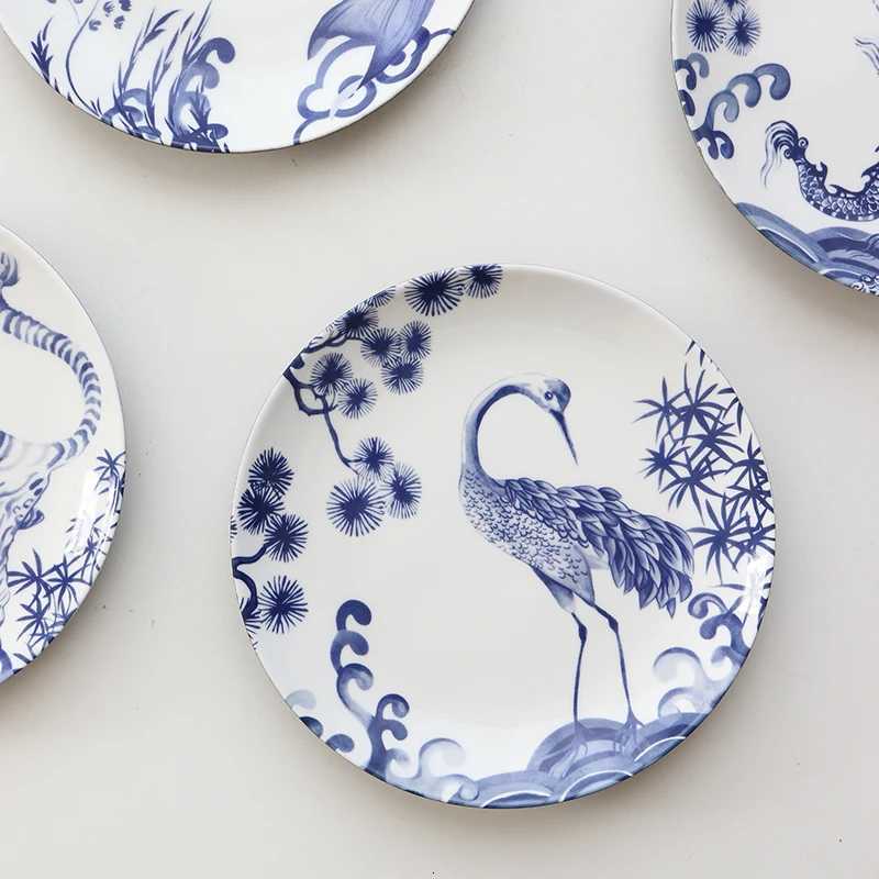 This set of four blue and white porcelain plates with dragon, tiger, and crane motifs brings auspicious charm to your home decor.T260304