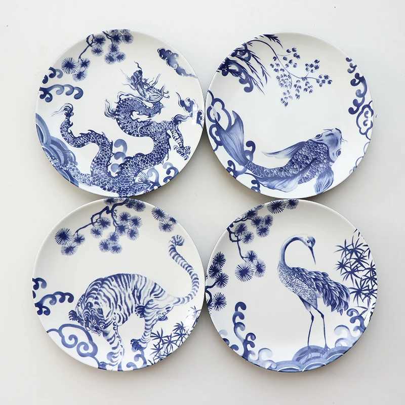 This set of four blue and white porcelain plates with dragon, tiger, and crane motifs brings auspicious charm to your home decor.T260304