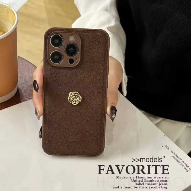 Luxury Suede Leather Metal Camellia Phone Case with Braided Wrist Strap For iPhone 17 Air 16 15 14 Plus 13 Pro Max 12 11 | Premium Skin-Feel Back Cove