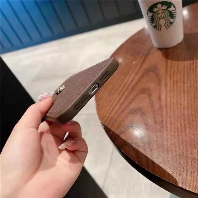 Luxury Suede Leather Metal Camellia Phone Case with Braided Wrist Strap For iPhone 17 Air 16 15 14 Plus 13 Pro Max 12 11 | Premium Skin-Feel Back Cove
