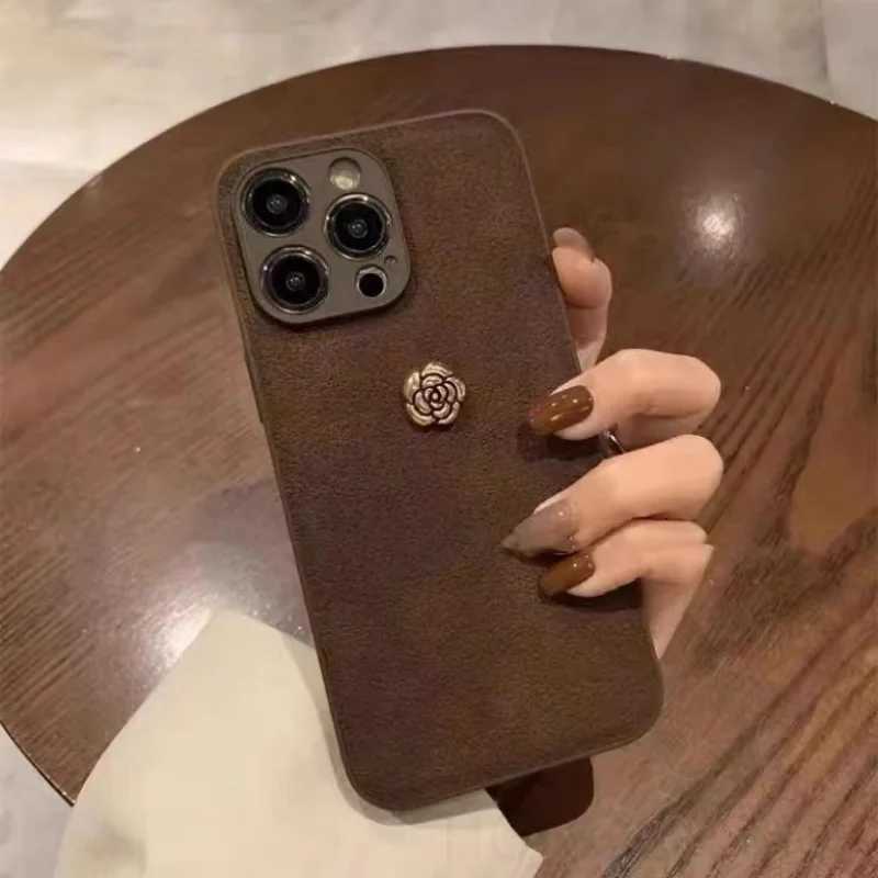 Luxury Suede Leather Metal Camellia Phone Case with Braided Wrist Strap For iPhone 17 Air 16 15 14 Plus 13 Pro Max 12 11 | Premium Skin-Feel Back Cove