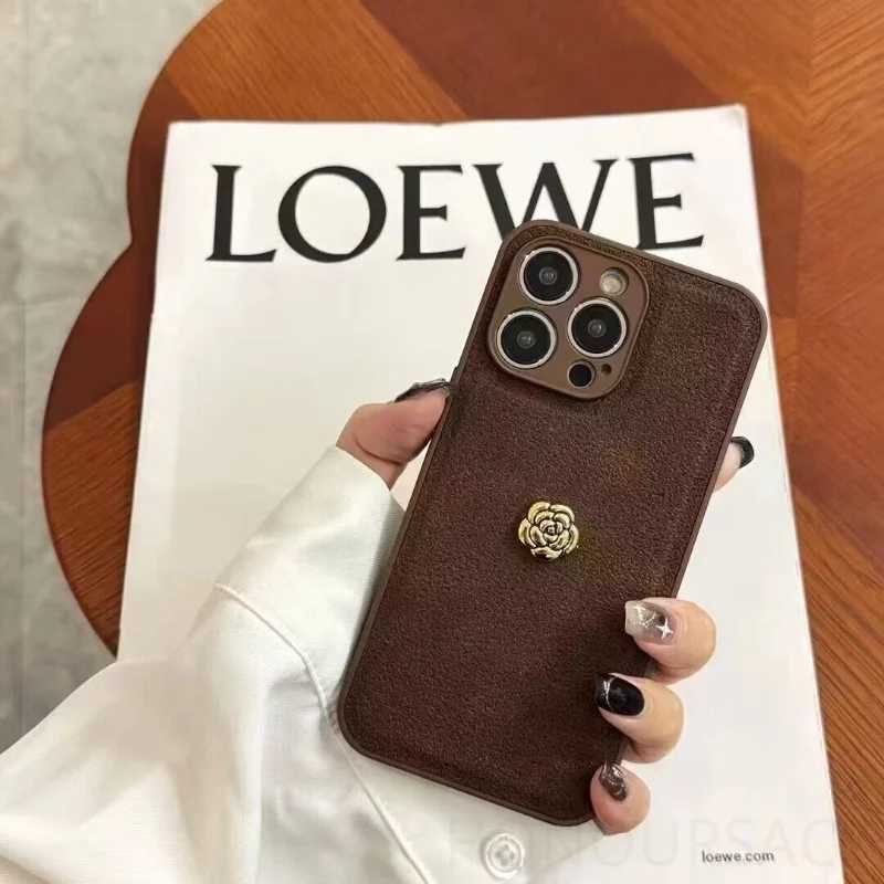 Luxury Suede Leather Metal Camellia Phone Case with Braided Wrist Strap For iPhone 17 Air 16 15 14 Plus 13 Pro Max 12 11 | Premium Skin-Feel Back Cove