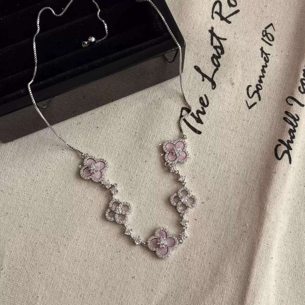 Elegant Pink Floral Design Charm Bangle: Four-Leaved Lucky Charms Accented by Tiny Sparkling Cubic Zirconia Stones for Women's Jewelry Collection