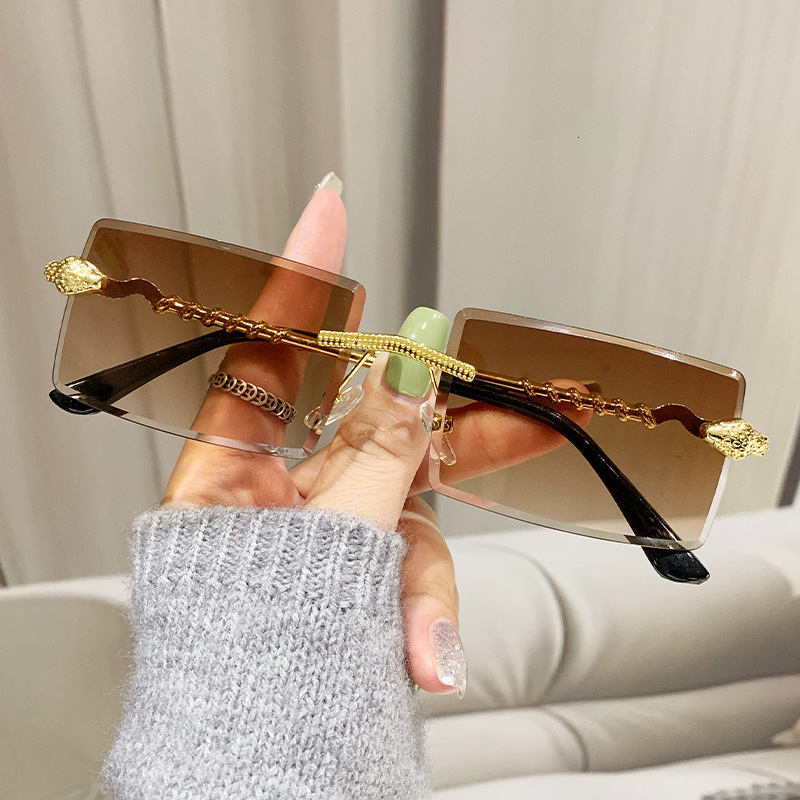 2026 New Designer Luxury Brand Fashion Personality INS Serpentine Frameless Sunglasses Outdoor Driving Fashion Street Style Value Sunglasses