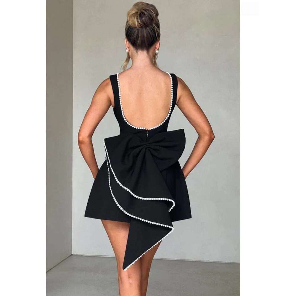 Designer's elegant mini dress with pearl bow details - perfect for parties, weddings, and special occasions