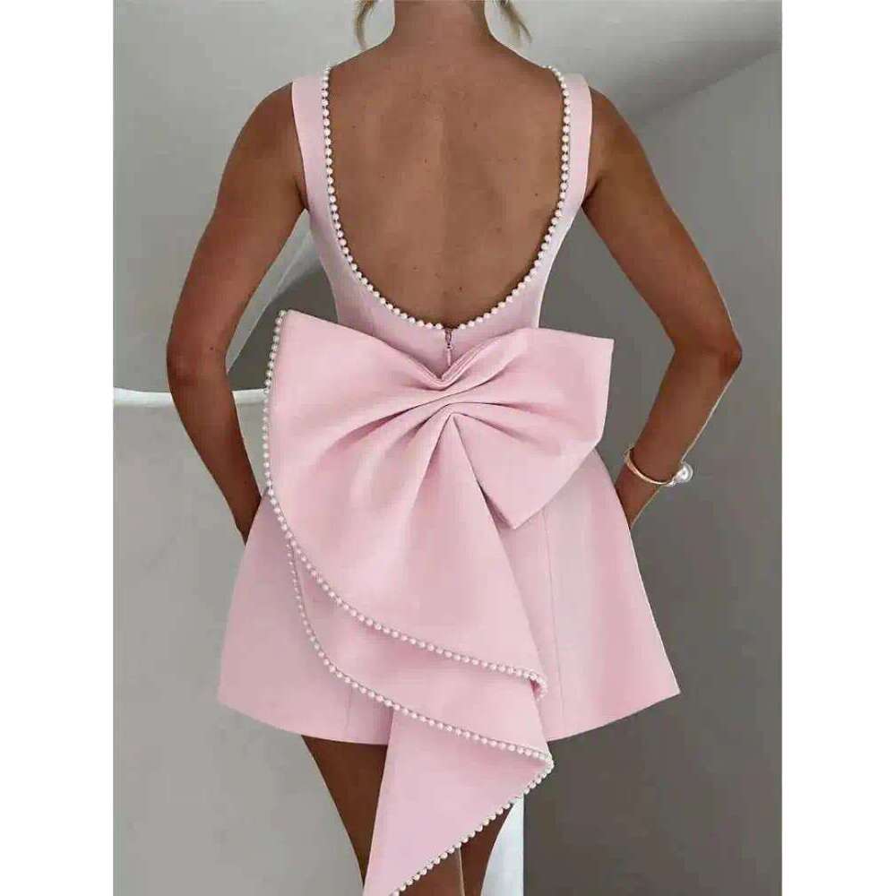 Designer's elegant mini dress with pearl bow details - perfect for parties, weddings, and special occasions