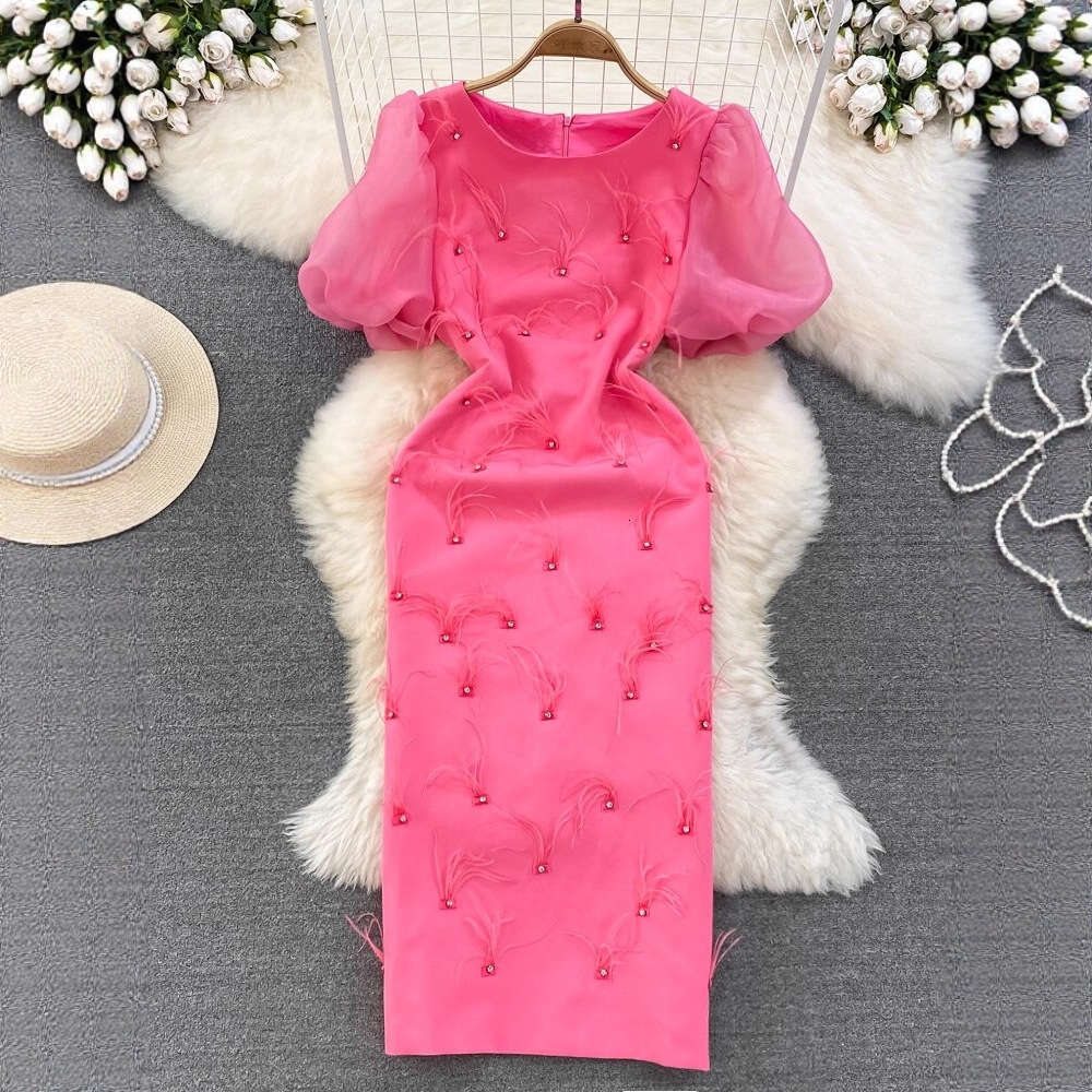 The designer's high-end luxury ladies' dress features bubble sleeves, round neck, and waist cinching design to highlight the mid length cut 