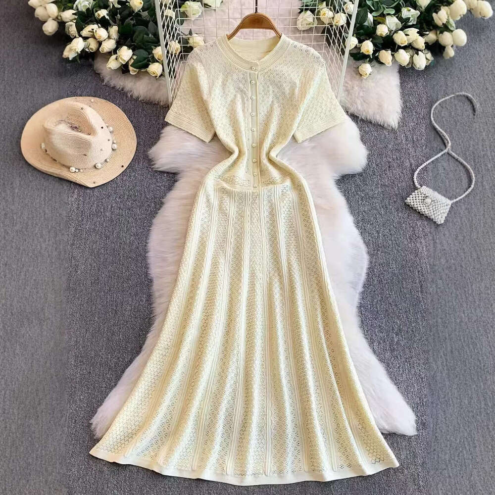 2026 French luxury socialite hollow round neck knitted women's autumn and winter high-end pearl slim elegant long skirt