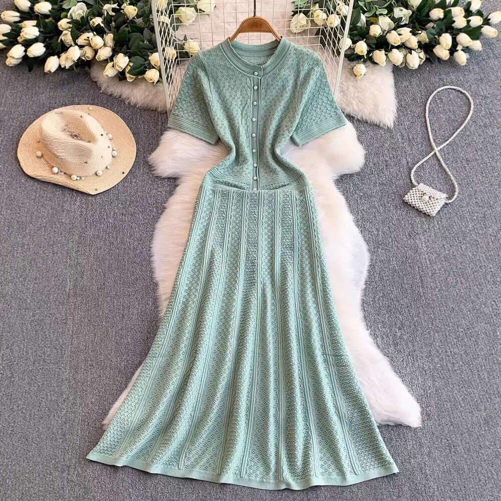 2026 French luxury socialite hollow round neck knitted women's autumn and winter high-end pearl slim elegant long skirt