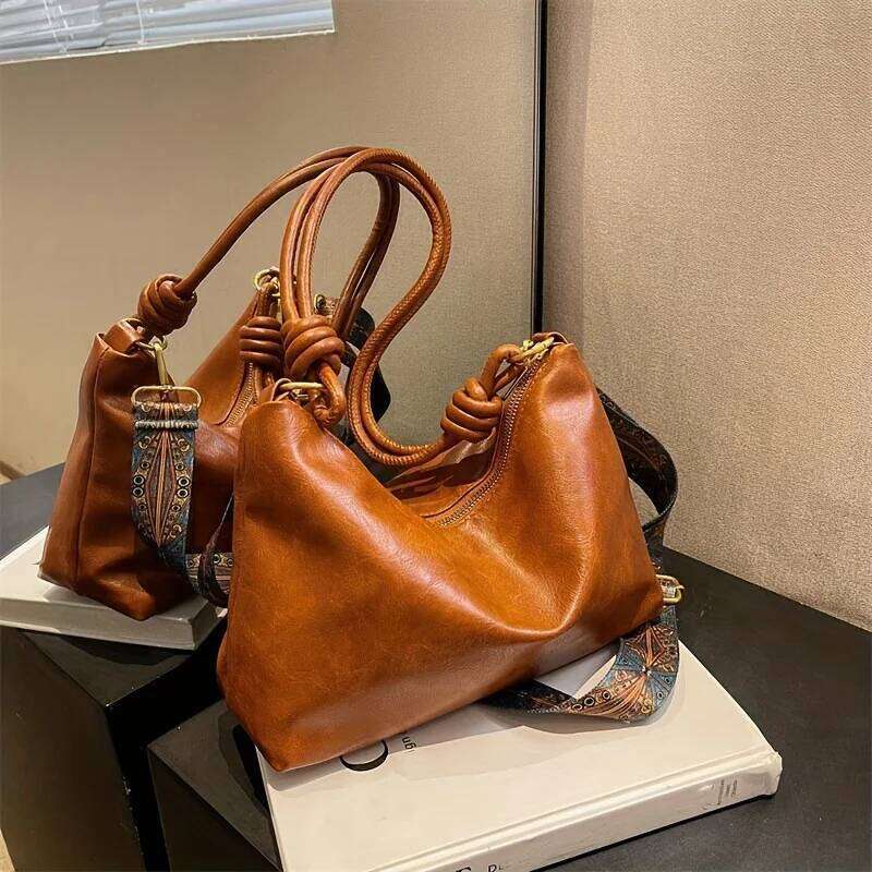 The new fashionable and high-end womens soft-touch shoulder bag is a geometric wide-band cross-body commuting handbag. XJ260306
